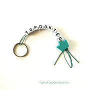 Sleutelhanger topdokter met gelukspoppetje kroontje