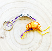 Name keychain with croissant lucky charm