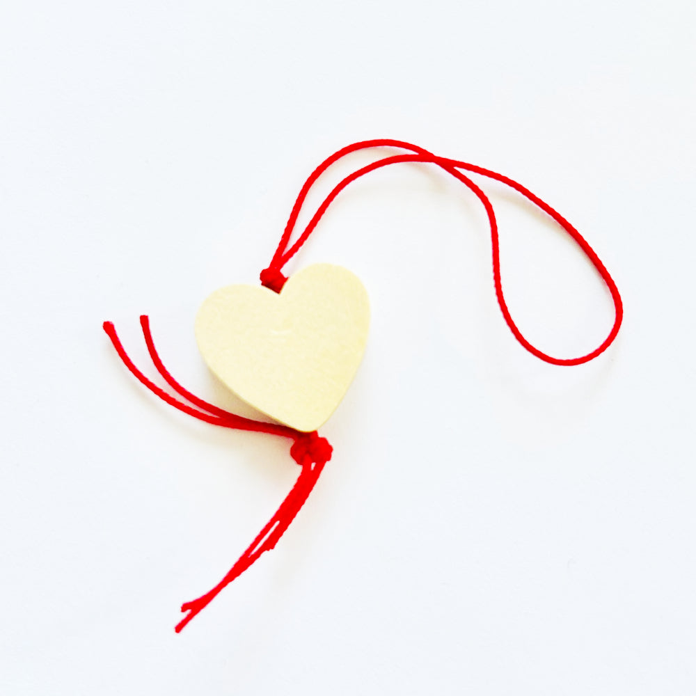 Wooden lucky charm heart with red string