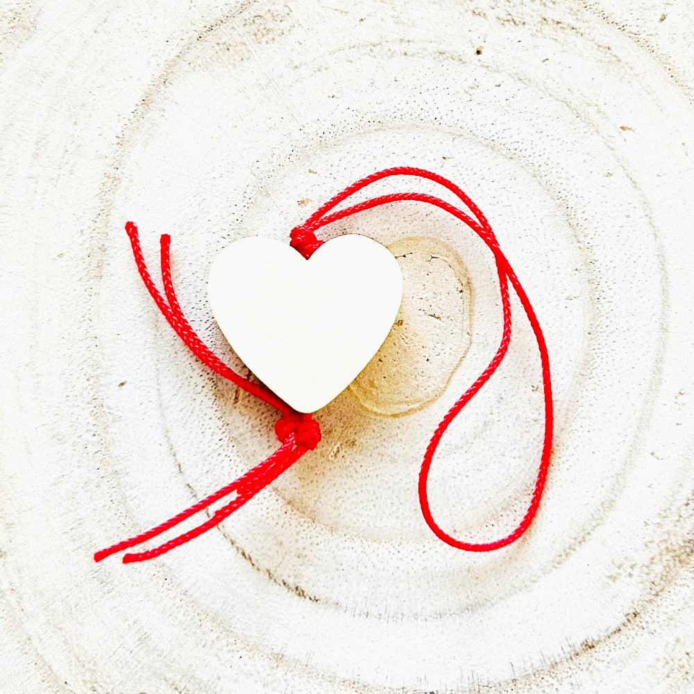 Wooden lucky charm heart with red string